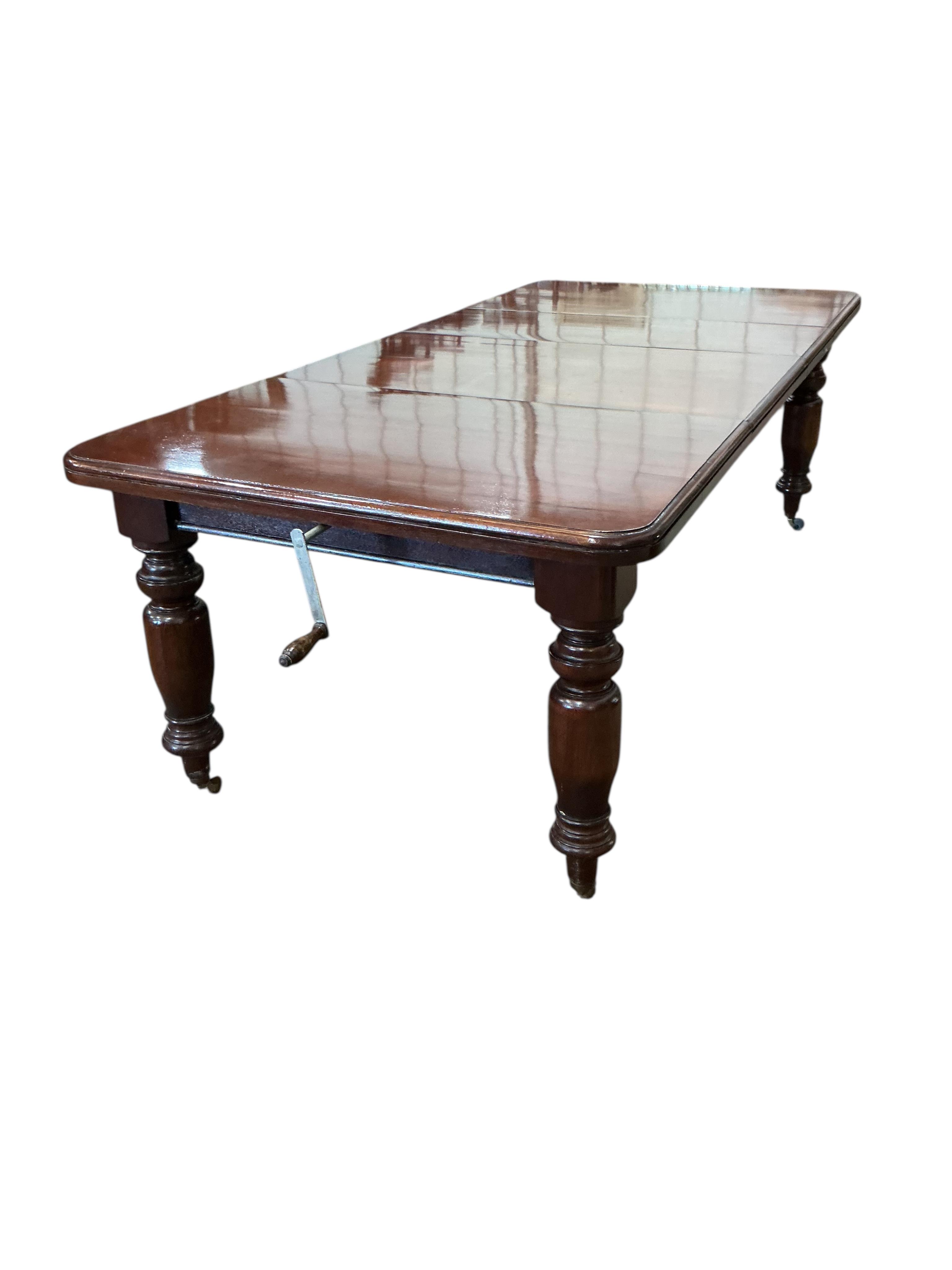 A Victorian style mahogany extending dining table, width 226cm extended, two spare leaves together with a set of eight Chippendale Revival mahogany dining chairs, two with arms